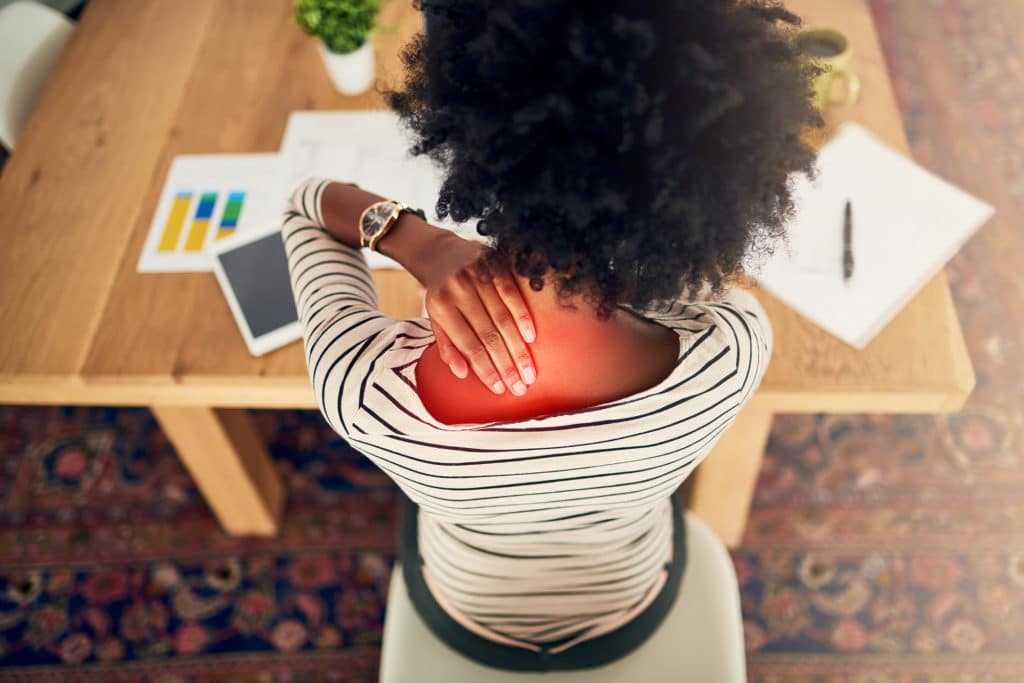 Woman rubbing neck with repetitive stress disorder