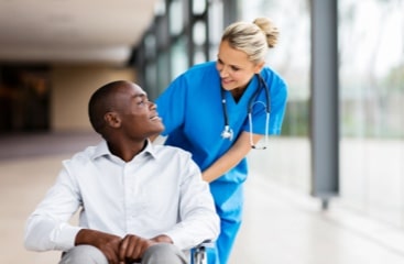 woman-nurse-pushing-man-in-wheelchair