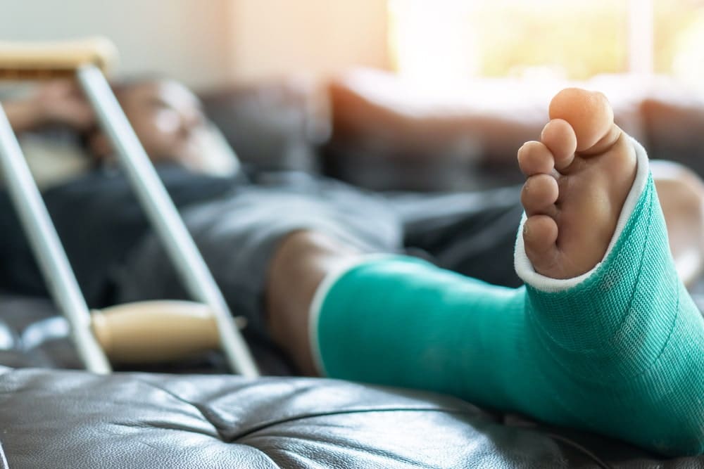 Man recovering from foot injury at home