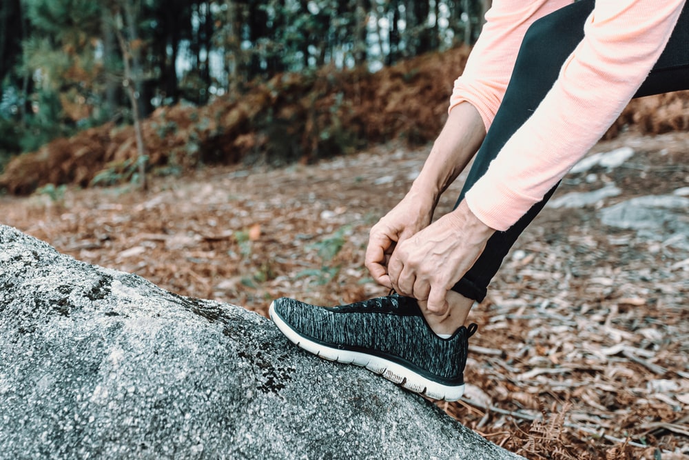 Woman tying her shoe before a run