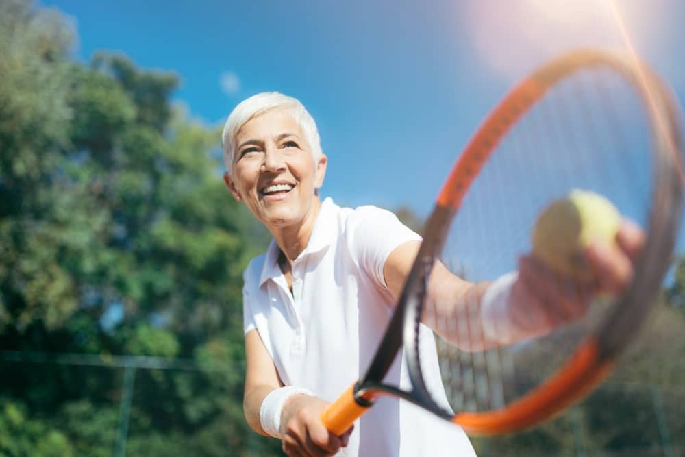 Older woman playing tennis