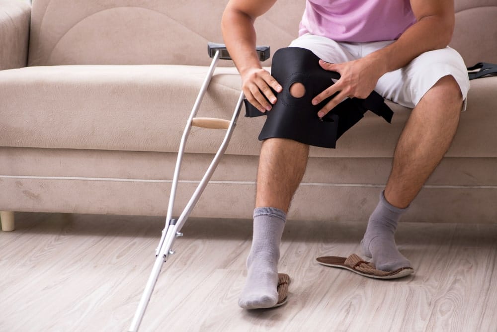 Man with knee brace after surgery