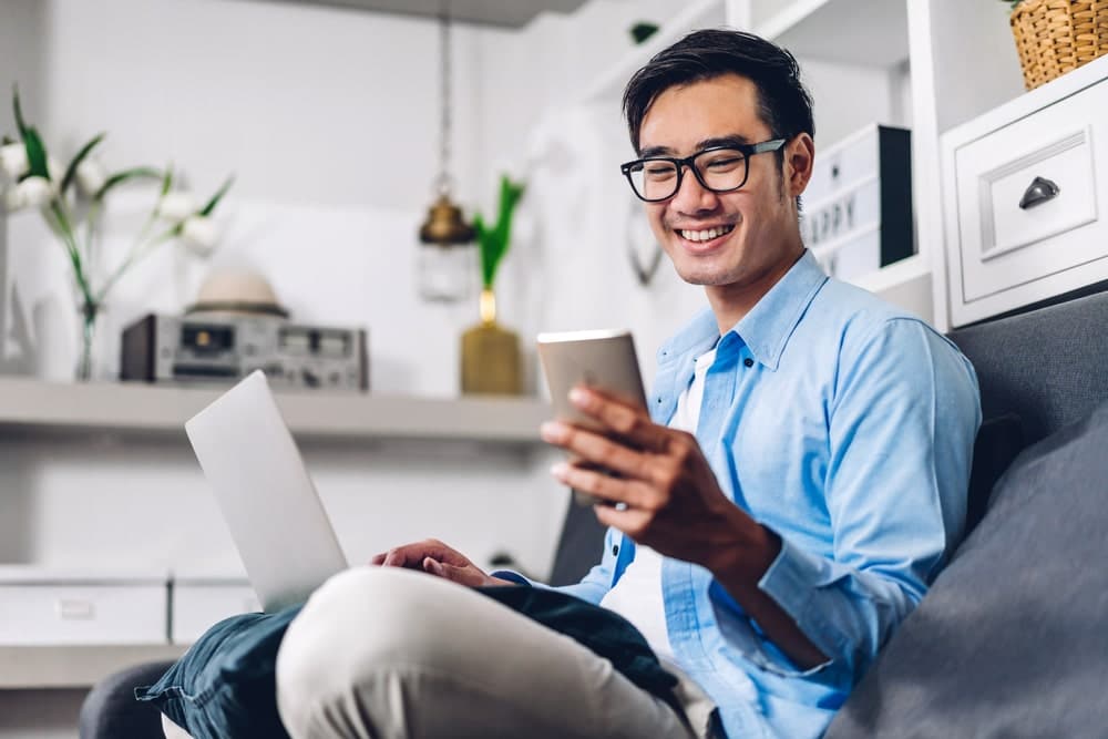 Asian man holding phone